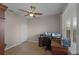 Home office with neutral walls, tile flooring, ceiling fan, and a view of the backyard at 7621 Brightwater Pl, Oviedo, FL 32765