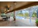 Covered patio area with a pool and a scenic backyard at 7621 Brightwater Pl, Oviedo, FL 32765