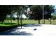 Outdoor basketball court in community with green space, basketball hoop and plenty of shade at 7682 Sir Kaufmann Ct, Kissimmee, FL 34747