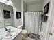 Bathroom with neutral colored walls, a shower with curtain, and a classic vanity sink at 7682 Sir Kaufmann Ct, Kissimmee, FL 34747