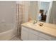 Bathroom featuring a bathtub, tiled shower, and a mirror reflecting the bedroom at 7682 Sir Kaufmann Ct, Kissimmee, FL 34747