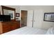 Bedroom featuring a dresser, mirror, open doorway to the bathroom, and two closets at 7682 Sir Kaufmann Ct, Kissimmee, FL 34747