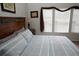 Bright bedroom featuring a comfortable bed and windows with natural light at 7682 Sir Kaufmann Ct, Kissimmee, FL 34747