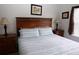 Bedroom featuring a decorative wood headboard with stylish lamps on both sides at 7682 Sir Kaufmann Ct, Kissimmee, FL 34747