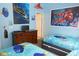 Whimsical bedroom with twin beds, Finding Nemo decor, dresser, and blue painted walls at 7682 Sir Kaufmann Ct, Kissimmee, FL 34747