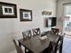 Dining area featuring a dark wood table set with seating for six with view to backyard at 7682 Sir Kaufmann Ct, Kissimmee, FL 34747