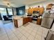 Well-equipped kitchen with stainless steel appliances, wood cabinets, and an open layout to the living area at 7682 Sir Kaufmann Ct, Kissimmee, FL 34747