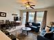 Inviting living room featuring a comfortable seating area and natural light from sliding glass doors at 7682 Sir Kaufmann Ct, Kissimmee, FL 34747
