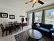 Inviting living room featuring a comfortable seating area and natural light from sliding glass doors at 7682 Sir Kaufmann Ct, Kissimmee, FL 34747
