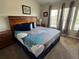 Comfortable main bedroom with a large bed, coordinating decor, and natural light from the windows at 7682 Sir Kaufmann Ct, Kissimmee, FL 34747