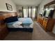 Comfortable main bedroom with a large bed, coordinating decor, and natural light from the windows at 7682 Sir Kaufmann Ct, Kissimmee, FL 34747