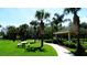 Picturesque community park with walking paths and picnic pavilion surrounded by palm trees at 7682 Sir Kaufmann Ct, Kissimmee, FL 34747