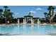 Large community pool with slides and shaded seating areas for relaxation and enjoyment at 7682 Sir Kaufmann Ct, Kissimmee, FL 34747