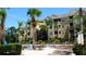 Resort-style condo community featuring a sparkling pool, palm trees, and plenty of lounge chairs at 7682 Sir Kaufmann Ct, Kissimmee, FL 34747
