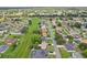 An aerial view of a suburban neighborhood with neatly arranged homes, green lawns, and mature trees at 857 Marquis Ct, Kissimmee, FL 34759