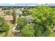 An aerial view of a home surrounded by lush greenery and trees showcasing the roof, screened-in porch, and neighborhood at 857 Marquis Ct, Kissimmee, FL 34759
