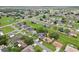 An aerial view of a suburban neighborhood featuring well-maintained homes, manicured lawns, and lush trees at 857 Marquis Ct, Kissimmee, FL 34759