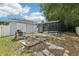 Backyard view of the property with a pool, fence, and green grass at 857 Marquis Ct, Kissimmee, FL 34759