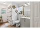 Updated bathroom featuring a modern vanity, toilet, decorative mirror and tiled shower at 857 Marquis Ct, Kissimmee, FL 34759