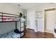 Functional bedroom with a bunk bed, closet, and view into the tiled bathroom at 857 Marquis Ct, Kissimmee, FL 34759