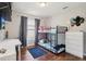 Comfortable bedroom with a desk and dresser and a cozy bunk bed near a bright window at 857 Marquis Ct, Kissimmee, FL 34759