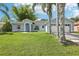 Charming blue single-story home features a well-manicured lawn, arched entryway, and a two-car garage at 857 Marquis Ct, Kissimmee, FL 34759