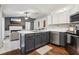 This shows the kitchen of the home with stainless steel appliances and bar top with an integrated sink at 857 Marquis Ct, Kissimmee, FL 34759