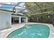 Enclosed pool area with blue painted home, tile pool, and lots of bamboo at 857 Marquis Ct, Kissimmee, FL 34759