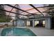 Back patio and pool with screened in enclosure, ideal for entertaining and relaxation at 857 Marquis Ct, Kissimmee, FL 34759