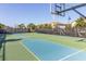 Community basketball court with palm trees and landscaping in the background for community recreation at 8912 Rhodes St, Kissimmee, FL 34747