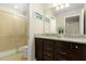 Bathroom featuring a glass-door shower and double vanity with a granite countertop at 8912 Rhodes St, Kissimmee, FL 34747