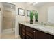 Bathroom featuring double sink vanity with granite countertop and glass-enclosed shower at 8912 Rhodes St, Kissimmee, FL 34747