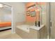 Bathroom featuring soaking tub and glass-enclosed shower at 8912 Rhodes St, Kissimmee, FL 34747