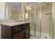 Modern bathroom with granite countertop vanity and glass-enclosed shower with tile surround at 8912 Rhodes St, Kissimmee, FL 34747