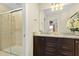 Bright bathroom with a glass-enclosed shower and double sink vanity featuring granite countertops and modern fixtures at 8912 Rhodes St, Kissimmee, FL 34747
