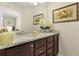 Elegant bathroom featuring a double sink vanity with granite countertops and decorative wall art at 8912 Rhodes St, Kissimmee, FL 34747