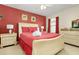 Inviting bedroom with red accent wall, a comfortable queen-size bed, and matching bedside tables at 8912 Rhodes St, Kissimmee, FL 34747