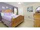 Comfortable bedroom featuring a full-size bed, ceiling fan, and closet at 8912 Rhodes St, Kissimmee, FL 34747