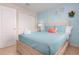 Inviting bedroom with light blue walls, a queen bed with decorative pillows, and a closet at 8912 Rhodes St, Kissimmee, FL 34747