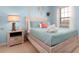 Charming bedroom featuring a queen bed with teal bedding, a decorative headboard, and a bedside table with a lamp at 8912 Rhodes St, Kissimmee, FL 34747
