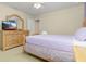 Bedroom featuring a comfortable full-size bed, dresser with a TV, and neutral decor at 8912 Rhodes St, Kissimmee, FL 34747
