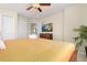Relaxing bedroom with a dark wood bed frame, a palm tree, and a mounted television at 8912 Rhodes St, Kissimmee, FL 34747