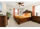 Elegant bedroom with a dark wood bed frame, soft lighting, and decorative accents at 8912 Rhodes St, Kissimmee, FL 34747