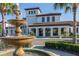 Community clubhouse featuring landscaping and water fountain in front of the main entrance at 8912 Rhodes St, Kissimmee, FL 34747