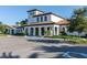 Exterior of the clubhouse featuring a modern architectural design and well-manicured landscaping at 8912 Rhodes St, Kissimmee, FL 34747
