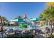 Community pool area with ' water slide, tables, and plenty of space to lounge around in the Florida sun at 8912 Rhodes St, Kissimmee, FL 34747