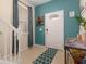 Bright entryway featuring tile flooring, staircase, and stylish decor with a turquoise wall at 8912 Rhodes St, Kissimmee, FL 34747