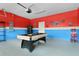 Spacious game room with a pool table, arcade game, and unique decor for Gathering fun at 8912 Rhodes St, Kissimmee, FL 34747