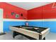 Fun game room with a pool table and vibrant red and blue walls, perfect for entertainment at 8912 Rhodes St, Kissimmee, FL 34747