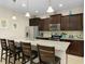 Spacious kitchen with granite counters, stainless steel appliances, and seating at the island at 8912 Rhodes St, Kissimmee, FL 34747
